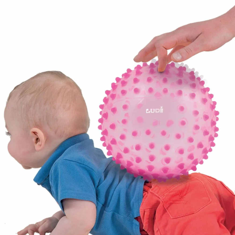 Ludi - Palla da massaggio rosa - Risveglio sensoriale per bambini dai 6 mesi - Puntine teneri - Stimolazione, Destrezza e Coordinazione - 100% PVC - Lavabile - Ø 20 cm - Allevia i denti e favorisce il